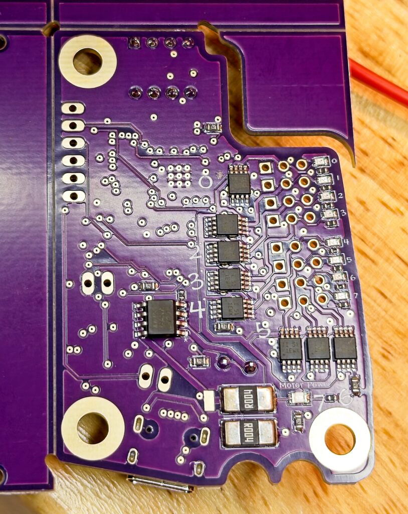A photo of the back of the 2025 edition of my Creature Controller. Eight power switch chips are visible.